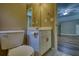 Bathroom featuring white toilet, vanity, and an open doorway into another room at 116 Woolsey Creek Trl, Fayetteville, GA 30215