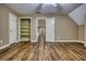 A spacious bedroom featuring hardwood floors, closet and door to hallway at 116 Woolsey Creek Trl, Fayetteville, GA 30215