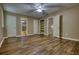 Large bedroom featuring hardwood floors, ceiling fan, closet and bathroom access at 116 Woolsey Creek Trl, Fayetteville, GA 30215