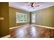 Bright bedroom with a ceiling fan and a large bay window showcasing outdoor views at 116 Woolsey Creek Trl, Fayetteville, GA 30215