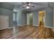 A bedroom with a ceiling fan, walk-in closet and access to a bathroom with tile flooring at 116 Woolsey Creek Trl, Fayetteville, GA 30215