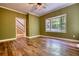 Spacious bedroom featuring hardwood floors, a ceiling fan, and a bright window at 116 Woolsey Creek Trl, Fayetteville, GA 30215