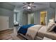 Bright bedroom with a ceiling fan, hardwood floors, and an attached bathroom at 116 Woolsey Creek Trl, Fayetteville, GA 30215