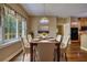Inviting dining room features hardwood floors, a decorative light fixture, and a large window at 116 Woolsey Creek Trl, Fayetteville, GA 30215