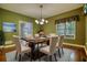 This dining room has elegant decor, hardwood floors, and a large window with natural light at 116 Woolsey Creek Trl, Fayetteville, GA 30215