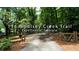 Long driveway with gated entrance leads to a wooded property at 116 Woolsey Creek Trail, Fayetteville, Georgia at 116 Woolsey Creek Trl, Fayetteville, GA 30215