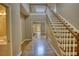 Inviting foyer with hardwood floors, staircase, and access to various rooms within the home at 116 Woolsey Creek Trl, Fayetteville, GA 30215
