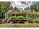 Charming home featuring a welcoming front porch with a beautifully landscaped yard and American flags displayed at 116 Woolsey Creek Trl, Fayetteville, GA 30215