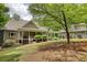 Charming home featuring a welcoming front porch with a beautifully landscaped yard and American flags displayed at 116 Woolsey Creek Trl, Fayetteville, GA 30215