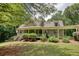 Charming home featuring a welcoming front porch with a beautifully landscaped yard and American flags displayed at 116 Woolsey Creek Trl, Fayetteville, GA 30215