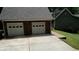 A stone garage and driveway with a brick walkway leads to the main house at 116 Woolsey Creek Trl, Fayetteville, GA 30215