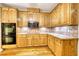 Well-equipped kitchen featuring wooden cabinets, tile backsplash, and modern appliances at 116 Woolsey Creek Trl, Fayetteville, GA 30215