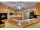 Functional kitchen with wood cabinets, tile countertops, and updated appliances, offering practical space at 116 Woolsey Creek Trl, Fayetteville, GA 30215