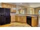 Functional kitchen with black appliances and wood cabinets offers ample storage and counter space at 116 Woolsey Creek Trl, Fayetteville, GA 30215