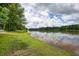 Scenic lake view with lush greenery and reflections of the sky in the water at 116 Woolsey Creek Trl, Fayetteville, GA 30215