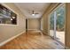 A light-filled living room with a ceiling fan, a sliding door to a deck, and wood floors at 116 Woolsey Creek Trl, Fayetteville, GA 30215