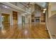 Open-concept living room with high ceilings, hardwood floors, and a stone fireplace with built-in shelves at 116 Woolsey Creek Trl, Fayetteville, GA 30215