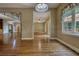 Open-concept living room with hardwood floors and large windows, providing plenty of natural light at 116 Woolsey Creek Trl, Fayetteville, GA 30215