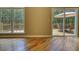 View of a living room with sliding glass doors to a deck with patio furniture and mature trees at 116 Woolsey Creek Trl, Fayetteville, GA 30215