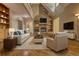 Spacious living room with stone fireplace, built-in shelving, and hardwood floors, perfect for gatherings at 116 Woolsey Creek Trl, Fayetteville, GA 30215