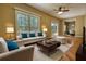 Bright living room features large windows, hardwood floors, and neutral decor with pops of blue at 116 Woolsey Creek Trl, Fayetteville, GA 30215