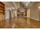 Spacious living room with hardwood floors and a striking stone fireplace, flanked by built-in shelving at 116 Woolsey Creek Trl, Fayetteville, GA 30215