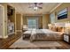 Relaxing main bedroom with a fireplace, wood ceiling, sitting area, and access to a private balcony at 116 Woolsey Creek Trl, Fayetteville, GA 30215