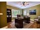 This office has hardwood floors, built-in shelving, a bay window, and a ceiling fan at 116 Woolsey Creek Trl, Fayetteville, GA 30215