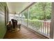 Inviting covered porch with rocking chair and views of the surrounding nature at 116 Woolsey Creek Trl, Fayetteville, GA 30215