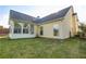 A well-maintained backyard featuring a sunroom and a lawn area perfect for relaxation and recreation at 121 St Albans Way, Peachtree City, GA 30269