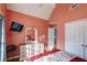 Cozy bedroom features a vaulted ceiling, a dresser with a mirror, and a wall-mounted television at 121 St Albans Way, Peachtree City, GA 30269