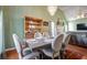 Elegant dining room with a chandelier, wooden hutch, and seating for six near the living area at 121 St Albans Way, Peachtree City, GA 30269