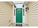 A vibrant green front door welcomes you to this charming home at 121 St Albans Way, Peachtree City, GA 30269