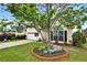 This charming home features a well-manicured lawn and a young ornamental tree at 121 St Albans Way, Peachtree City, GA 30269