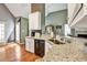 Kitchen showcasing granite counters, stainless sink, hardwood flooring and breakfast bar at 121 St Albans Way, Peachtree City, GA 30269