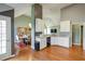 Open kitchen with granite countertops, white cabinets, stainless steel sink and hardwood floors at 121 St Albans Way, Peachtree City, GA 30269