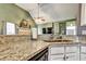 Kitchen featuring a stainless steel sink, granite countertops and views of the living space at 121 St Albans Way, Peachtree City, GA 30269