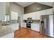 Bright kitchen with stainless steel appliances, granite countertops, and hardwood flooring at 121 St Albans Way, Peachtree City, GA 30269