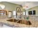 Kitchen showcasing a stainless steel sink, granite countertops, and hardwood floors at 121 St Albans Way, Peachtree City, GA 30269