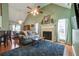 Inviting living room features a fireplace, ample natural light, and comfortable seating arrangements at 121 St Albans Way, Peachtree City, GA 30269