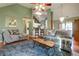 Open-concept living room features a comfortable seating, a hardwood floor, and plenty of light at 121 St Albans Way, Peachtree City, GA 30269
