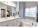 Serene bathroom with a double vanity, soaking tub, and plenty of natural light at 121 St Albans Way, Peachtree City, GA 30269