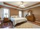Comfortable main bedroom featuring trey ceilings, ceiling fan, and plush carpet at 121 St Albans Way, Peachtree City, GA 30269