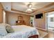 Comfortable main bedroom featuring trey ceilings, ceiling fan, and hardwood floors at 121 St Albans Way, Peachtree City, GA 30269