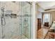Modern bathroom with a glass-enclosed shower featuring elegant tile and a rainfall showerhead at 121 St Albans Way, Peachtree City, GA 30269
