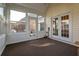 Relaxing sun room filled with natural light, leading to the outdoor patio through glass paneled doors at 121 St Albans Way, Peachtree City, GA 30269