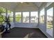 Bright sunroom with large windows offering backyard views and workout equipment at 121 St Albans Way, Peachtree City, GA 30269