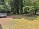 Large backyard featuring mature trees and a deck to the left at 2247 Green Forrest Dr, Decatur, GA 30032
