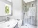 Updated bathroom featuring a tiled walk-in shower, a modern vanity, and a window at 2247 Green Forrest Dr, Decatur, GA 30032