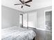 Bright bedroom features a ceiling fan, neutral walls, and dark hardwood floors at 2247 Green Forrest Dr, Decatur, GA 30032